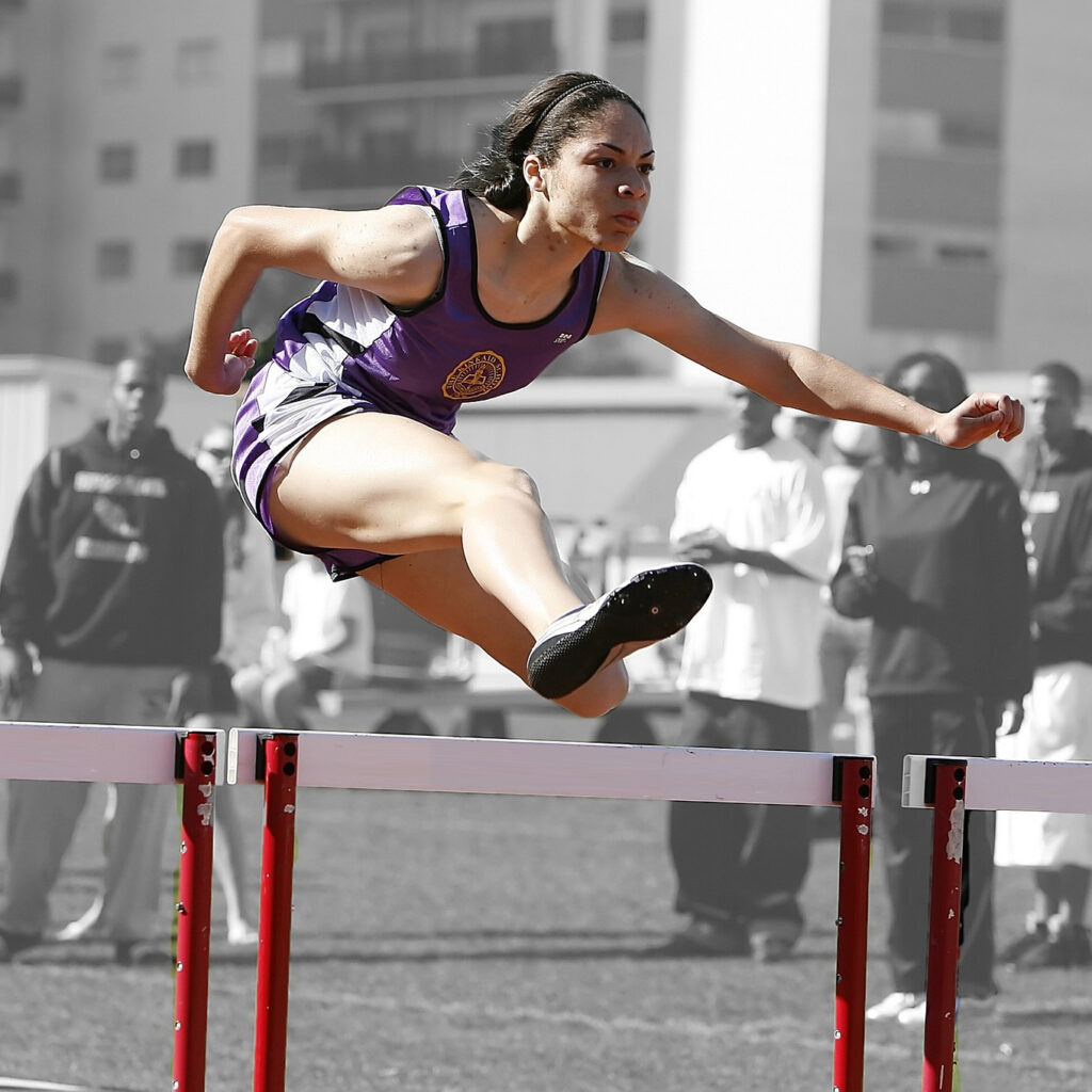 Woman athlete doing hurdles