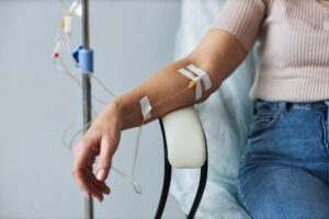 woman getting iv therapy - close up of hand with iv therapy