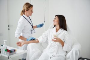 A woman receiving IV therapy for hydration and vitamin restoration.