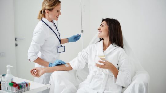 A woman receiving IV therapy for hydration and vitamin restoration.