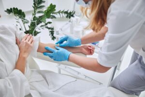 A woman receiving an IV Vitamin therapy at a clinic.