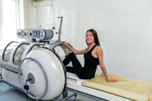 A woman prepping to get into a Hyperbaric Oxygen Therapy chamber to help treat her illness.