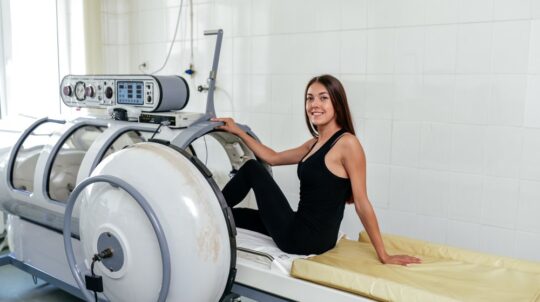 A woman prepping to get into a Hyperbaric Oxygen Therapy chamber to help treat her illness.