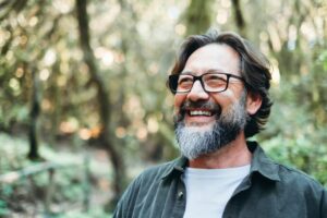 A man smiling outside while enjoying the fresh air.