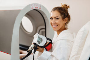 woman with oxygen mask going into hyperbaric oxygen therapy chamber