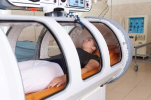 Girl patient lying in a hyperbaric chamber.