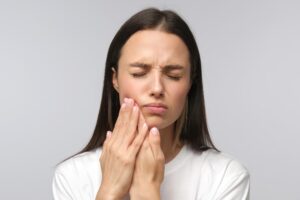 A woman suffering from an oral infection and in need of ozone therapy treatment.