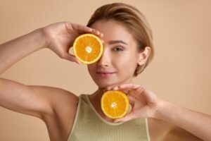 Natural Makeup and Glowing Hydrated Skin. Vitamin C Cosmetics Concept.